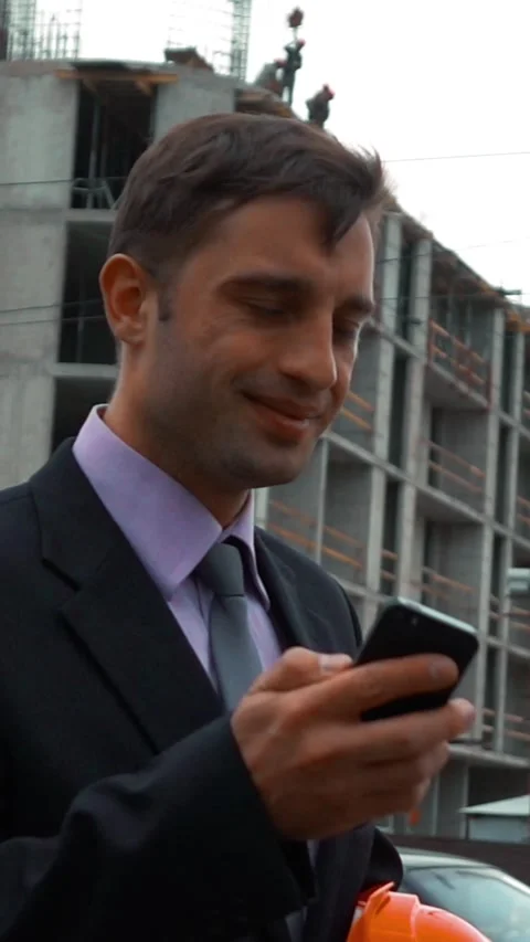 Vertical of Attractive construction engineer answering call. Stock Footage 305498452