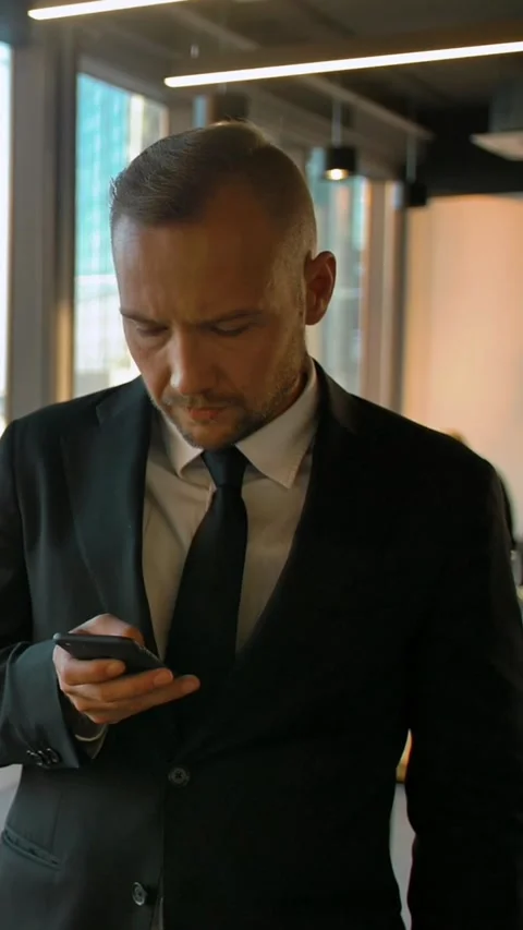 Vertical of Attrtactive entrepreneur in formal suit standing near window and Stock Footage 277280656