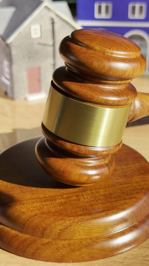 Vertical - Auction concept: A gavel rocking on its block and model properties. Stock Footage 302271097