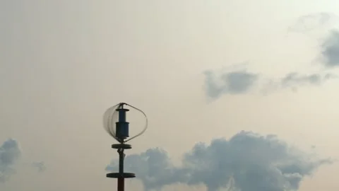 Vertical axis wind turbine generating electric energy against blue sky. Stock Footage 148651141