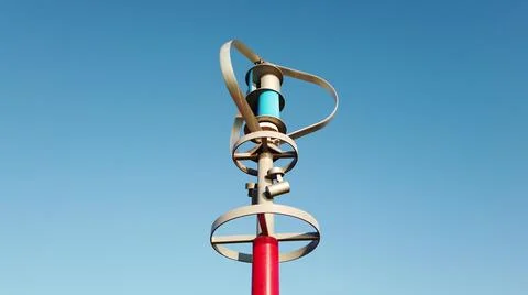 Vertical axis wind turbine generating electric energy while spinning. Stock Photos
