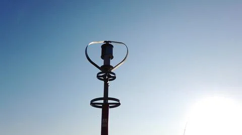 Vertical axis wind turbine utilize renewable wind energy while spinning. Stock Photos