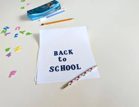 Vertical back to school concept featuring dark blue fabric letters arranged o Stock Photos