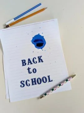 Vertical back to school concept featuring dark blue fabric letters arranged o Stock Photos