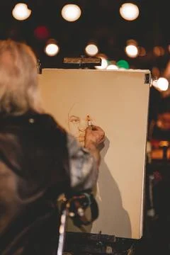 Vertical back shot of a painter at night. Paris, France Stock Photos