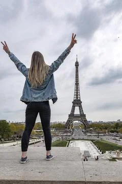 Vertical back view of a female with the Eiffel Tower in the background in Par イラスト素材