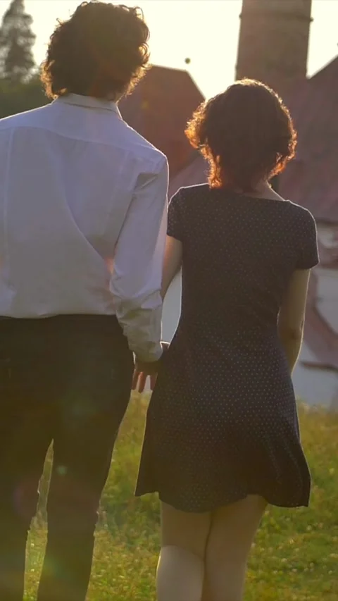 Vertical of Back view of young couple in love walks with the Gatchina Priory Stock Footage 278481247
