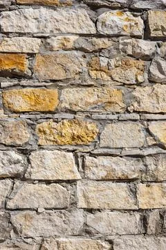 Vertical background in the form of natural stonework. Stock Photos