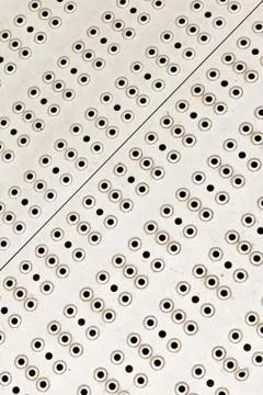 Vertical background metal surface diagonal row set of round holes holes indus 스톡 사진