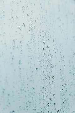 Vertical background of some rain drops over a crystal surface Stock Photos
