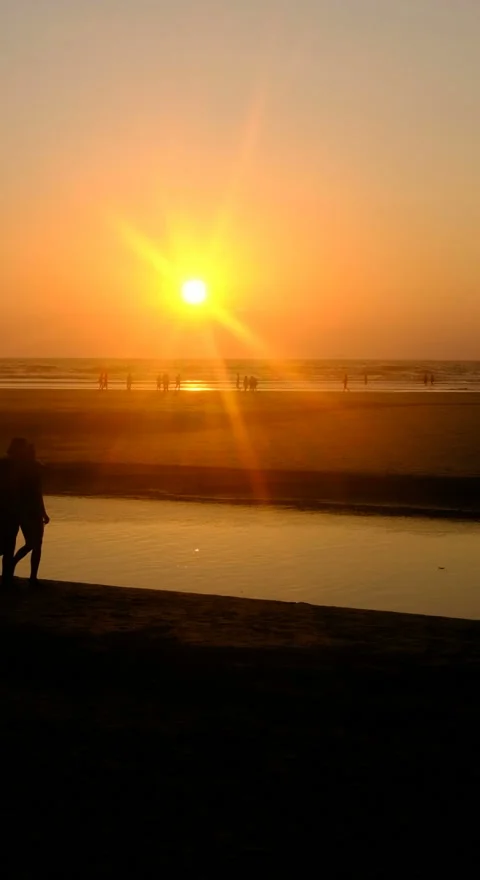 Vertical Background Walking People silhouettes on the Sunset beach Stock Footage 121529964