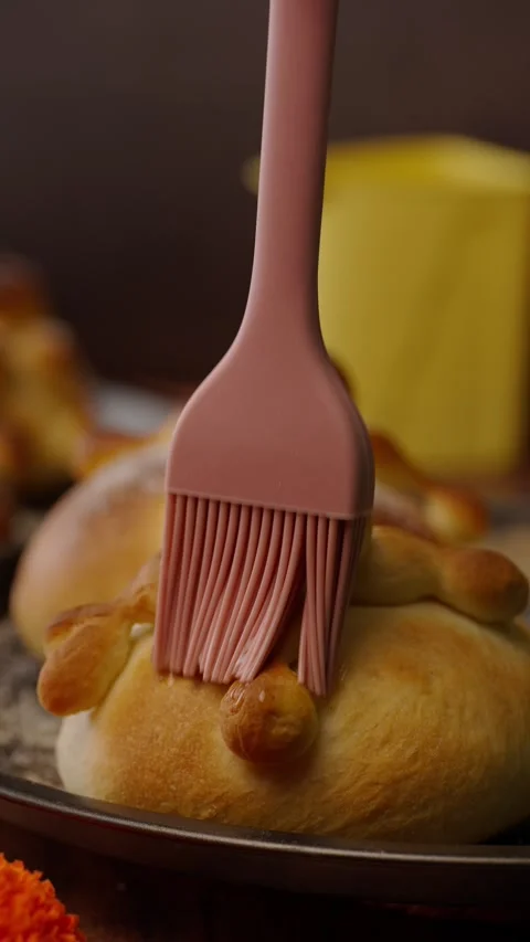 Vertical bakery video, Pan de muerto or hojaldras glazed with melted butter Stock Footage 282499333