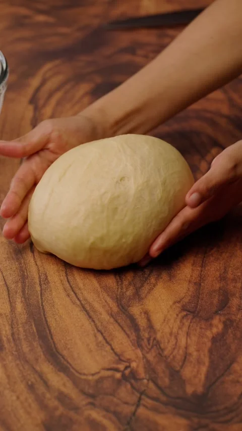 Vertical bakery video, Rolling yeast dough to make bread Stock Footage 282499321