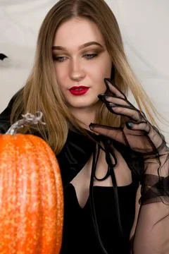 Vertical banner with evil witch putting spell on the pumpkin.Halloween concep Stock Photos