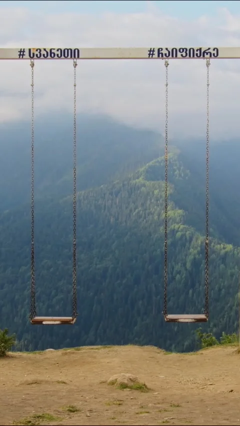 Vertical banner Iconic giant empty wooden swings at Heshkili huts viewpoint.. 스톡 동영상 332053446