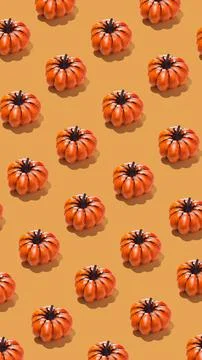Vertical banner with pumpkin pattern on orange background. Stock Photos