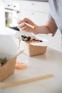Vertical banner with unrecognizable man eating poke bowl with salmon,seaweed Stock Photos