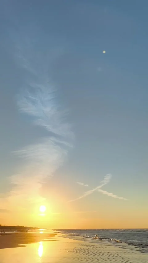 Vertical Beach Sunset Golden Hour with Moon and Feather Clouds Stock Footage 340381680