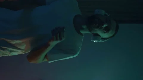 Vertical bearded man dance alone indoor. Wearing wireless headphones, enjoying Stock Footage 166870596