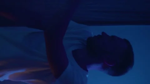 Vertical bearded man dance alone indoor. Wearing wireless headphones, enjoying Stock Footage 168169131
