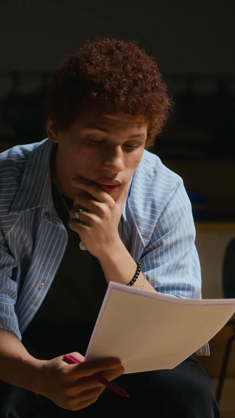 Vertical of Biracial Actor Reading Script during Acting Rehearsal in Theater Stock Footage 344533942