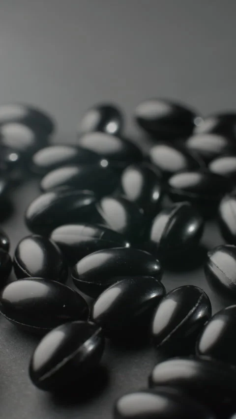 Vertical Black Astaxanthin Softgels Static Macro Video stock 332369734