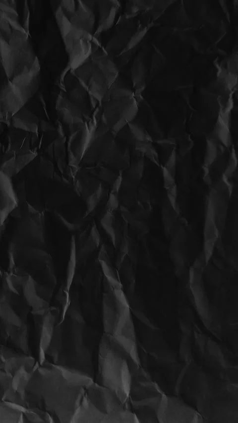 Vertical black crumpled paper texture creates a dark tactile surface, a 4K .. Stock Footage 337771556