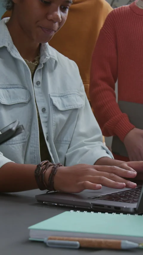 Vertical of Black Female Student Working on Laptop and Classmates Watching Stock Footage 318728428