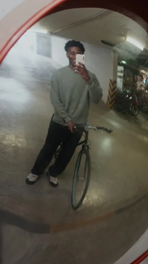 Vertical of Black Guy Taking Mirror Selfie in Parking Space Stock Footage 321054078