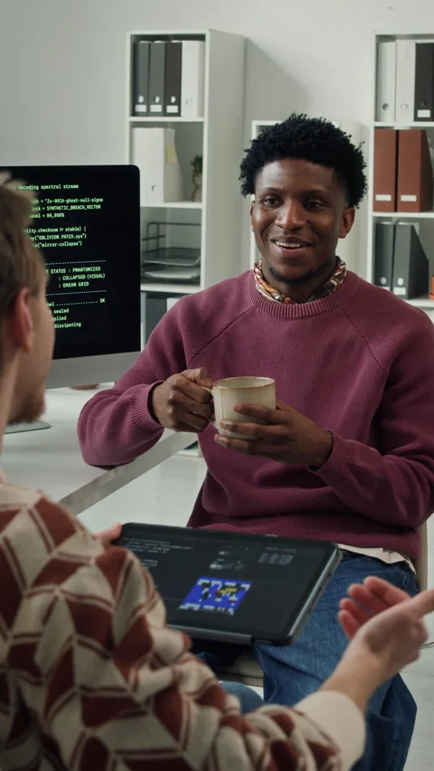Vertical of Black Male Programmer Talking with Colleague during Coffee Break Stock Footage 330132367