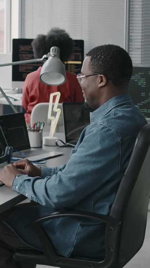 Vertical of Black Male Software Engineer Coding on Computer in Office Stock Footage 276402137