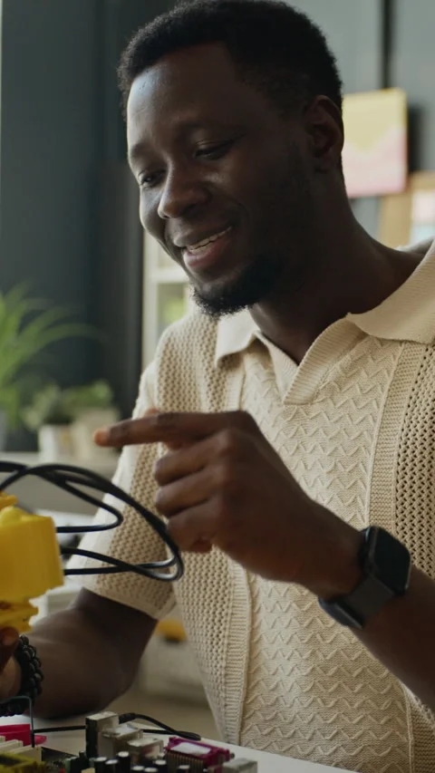 Vertical of Black Man Presenting Robotic Device in Stem Class Stock Footage 340554135