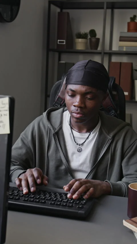 Vertical of Black Man Software Developer Typing on Keyboard and Coding in Office Stock Footage 336710535