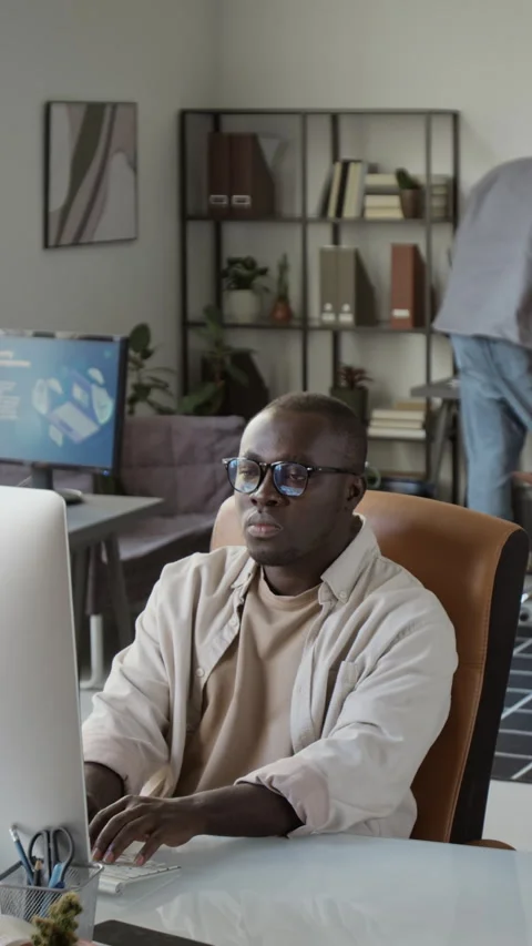 Vertical of Black Man Working on Desktop Computer in Modern Office Stock Footage 348142095