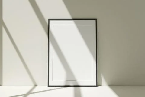 Vertical black photo frames mockup on the floor leaning against the room wa.. Stock-Fotos