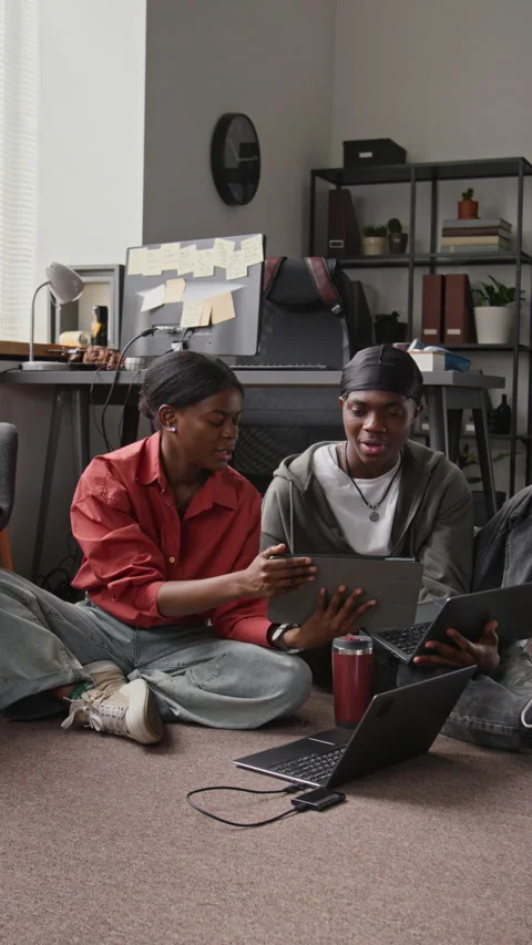 Vertical of Black Programmers Collaborating on Tablet in Creative Office Stock-Footage 336719106