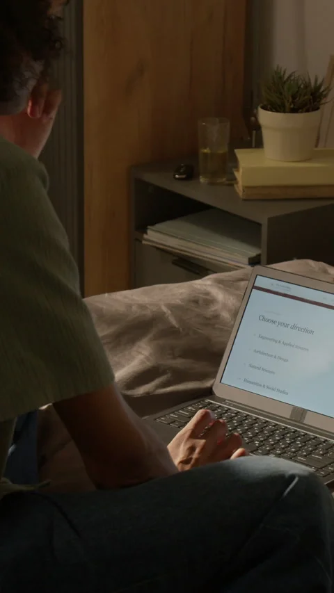 Vertical of Black Student Choosing University Courses on Laptop Screen Stock Footage 338088076