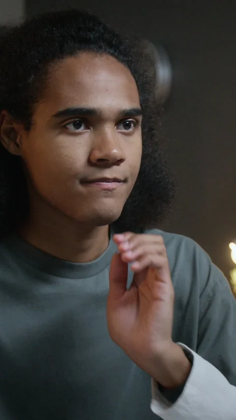 Vertical of Black Teenager Thinking While Typing on Computer Keyboard Stock Footage 348141691
