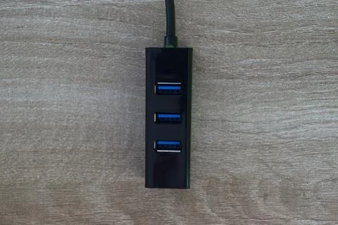 Vertical black USB hub top view on wood Stock Photos