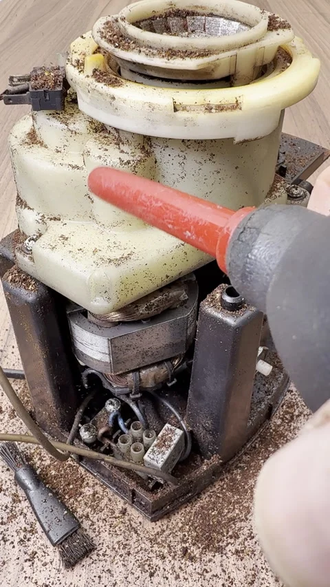 Vertical - A blower removing coffee dust from inside an electric grinder. Stock-Footage 304989798