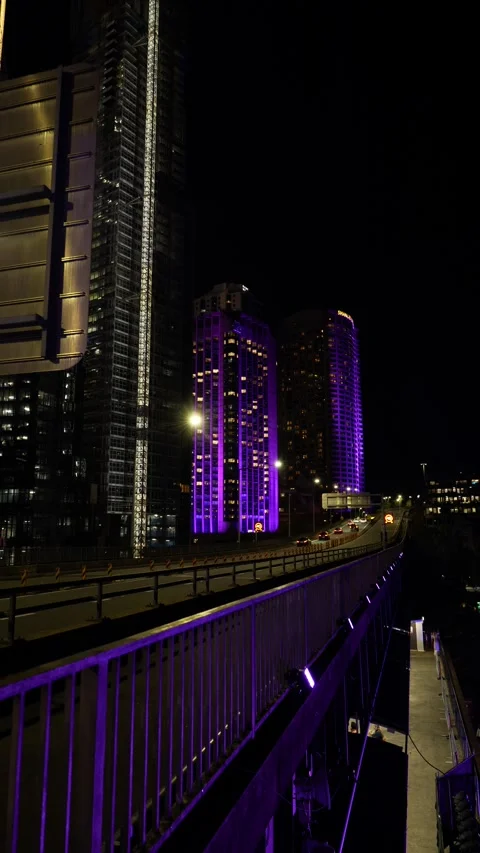 Vertical Blue changes to purple neon buildings and Sydney traffic 6K Stock Footage 310386282