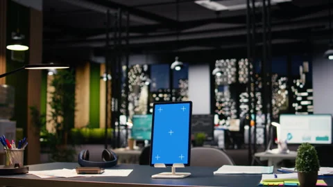 Vertical blue display tablet in contemporary empty office workspace Stock Footage 334039819