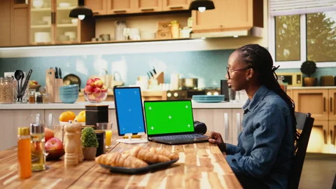 Vertical blue screen and chroma key on tablet and laptop near female worker Stock Footage 344245261