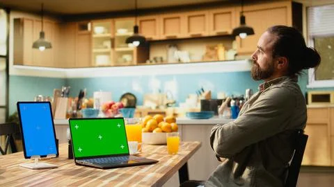 Vertical blue screen and chroma key on tablet and laptop near male adult Stock Photos