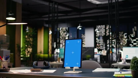 Vertical blue screen tablet in empty corporate office with spacious open space Stock Footage 334039834