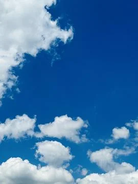 Vertical Blue Sky With Fluffy White Clouds Background. Stock Photos