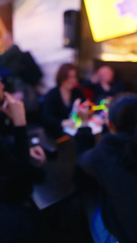 Vertical Blurred Scene: Friends Playing Quiz Game in Pub Stock Footage 276392248
