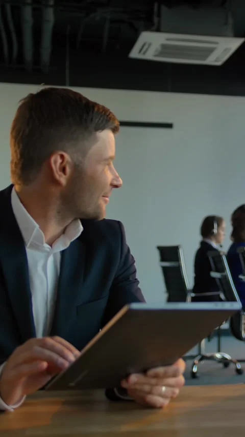 Vertical of Boss enterpreneur with digital pad communicate in call center Stock Footage 277279153