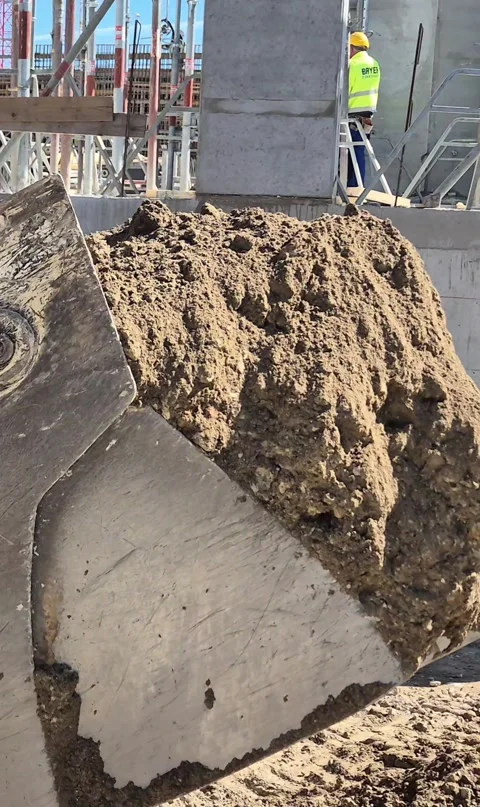 Vertical Bottom View of Construction Vehicle Moving Earth Stock Footage 334993863