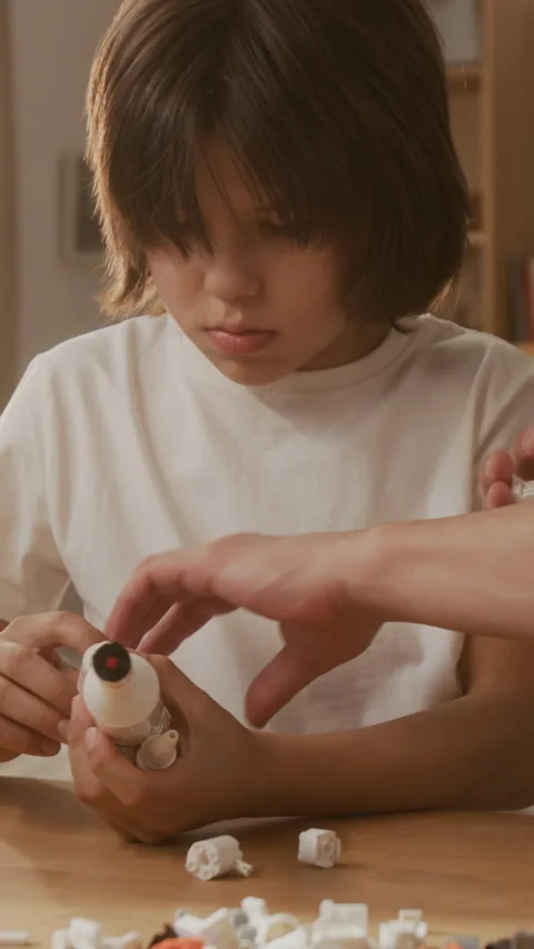 Vertical of Boy with Father Assembling Toy Space Rocket for Stem Learning Stock Footage 336175512